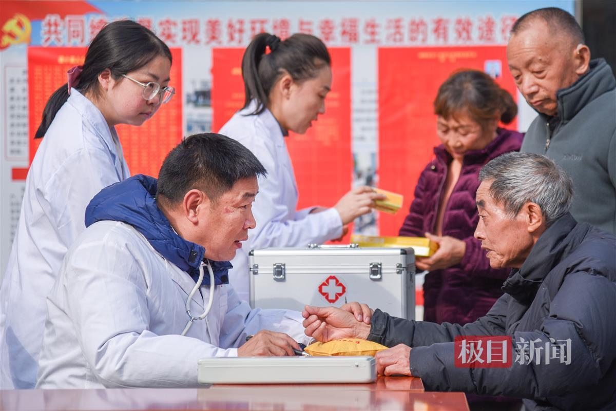 12月6日，彭贤钊（前左）在荆州经开区滩桥镇新桥社区，为滩桥新城小区居民义诊。 （极目新闻记者 黄志刚 摄）.jpg