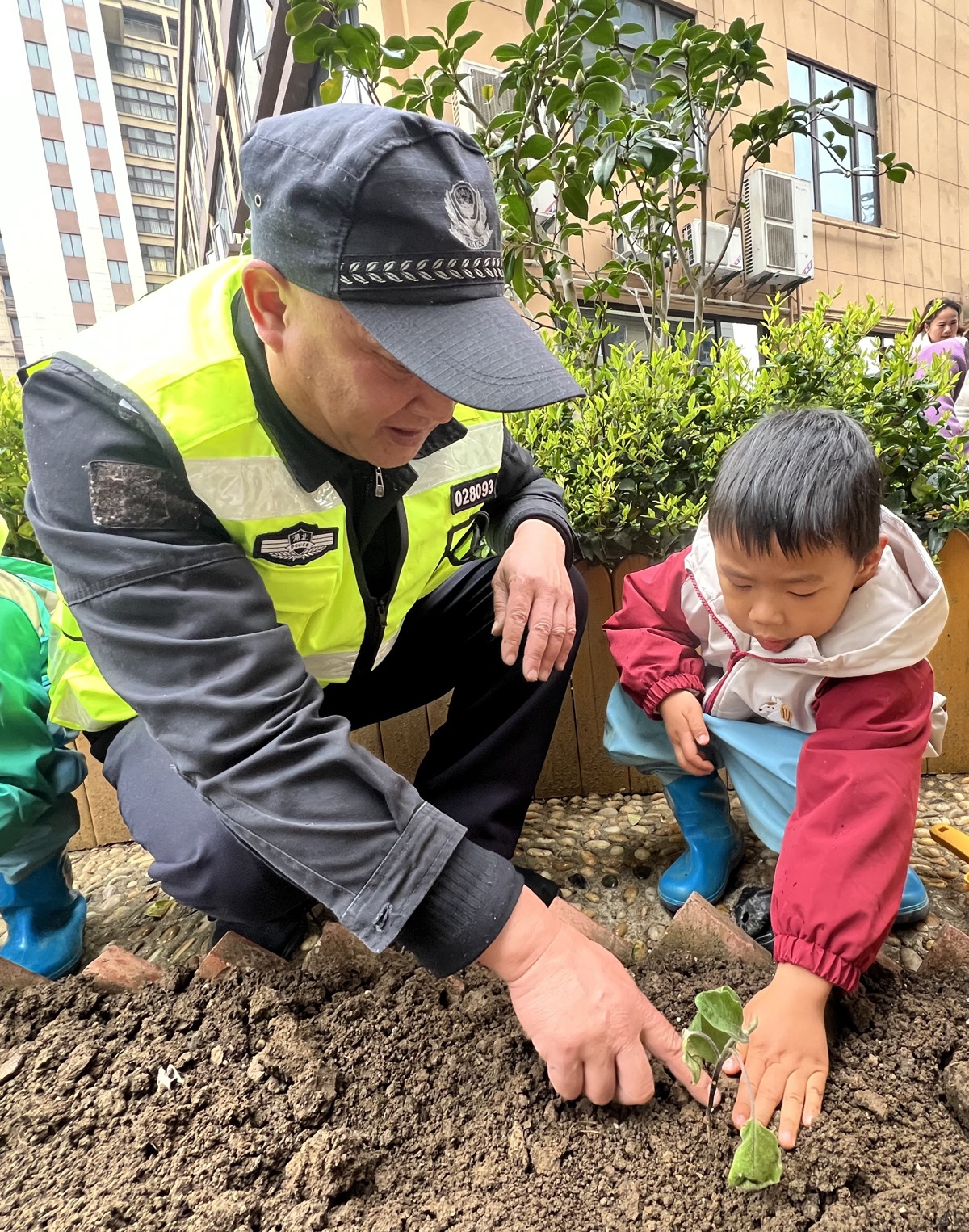 社区民警与孩子一起种植.JPG