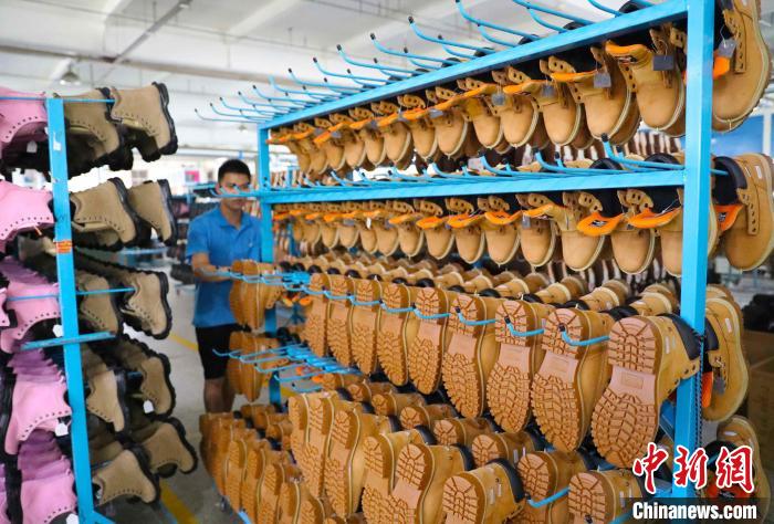 6月17日，在山东高密一家劳保鞋生产企业，工人在运送成品入库。　张进刚 摄