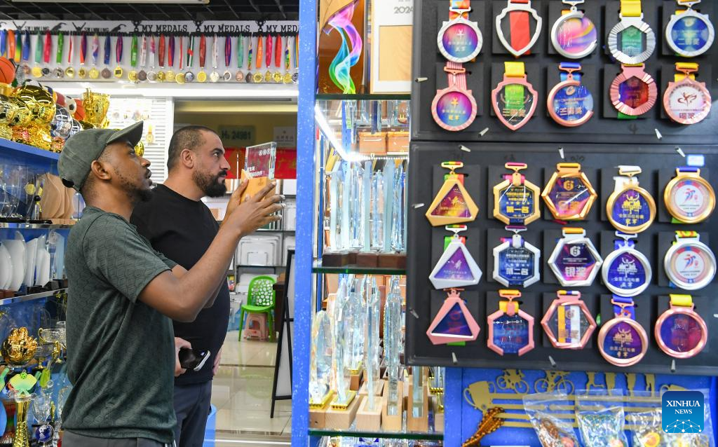 Foreign clients purchasing sports goods in Yiwu International Trade City.