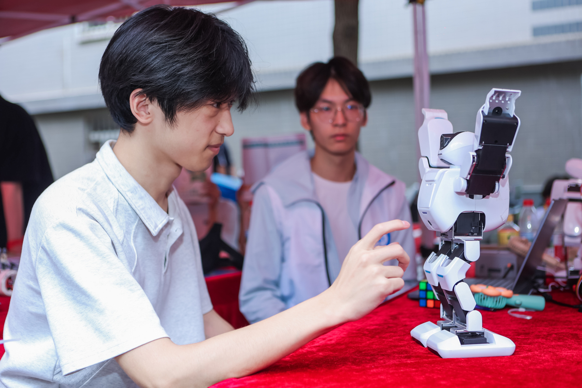 图为学生在操作小型智能机器人 摄影:佳航.jpg 图为学生在操作小型智能机器人 摄影:佳航.jpg