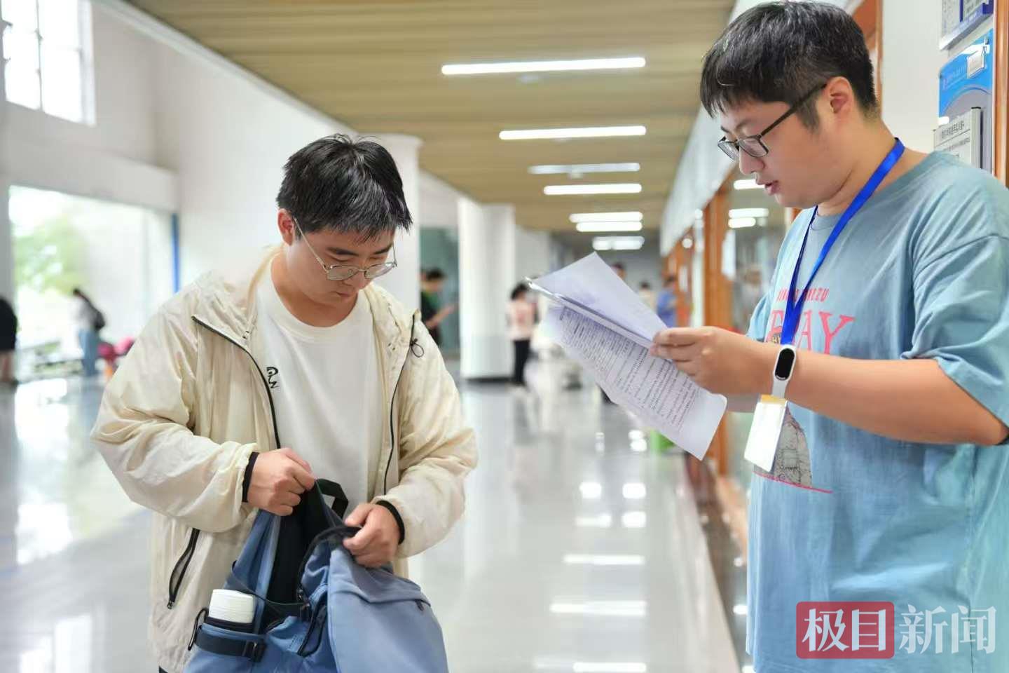 2、武汉软件工程职业学院考点现场，监考官在核对考生信息。张扬摄.jpg