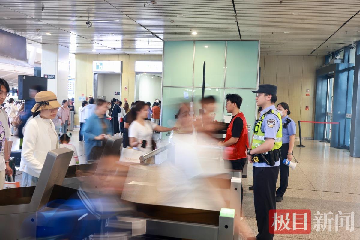 武汉铁路公安处武汉站派出所民警在检票闸机立岗，维护旅客出行秩序。.jpg